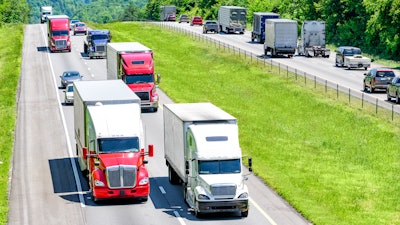 Trucks driving down hill on highway