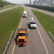 Freightliner trucks on isolated highway from above