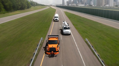 Freightliner trucks on isolated highway from above