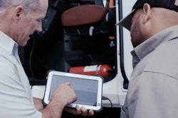 Two men using tablet during service event