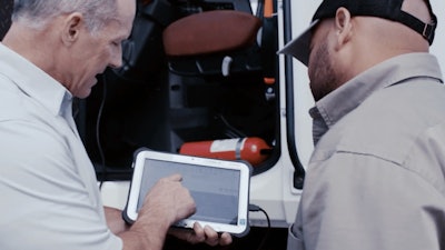 Two men using tablet during service event