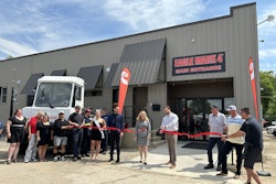 A man cuts a ribbon in front of Eagle Mark 4.