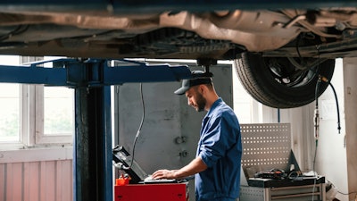 Technician using computer in a shop
