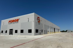 A large, gray building with the Forge Truck Centers logo