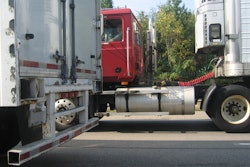 Red truck between two trailers