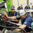 Two men work on a truck at the Volvo VISTA World Championships