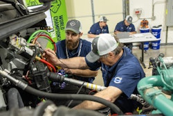 Two men work on a truck at the Volvo VISTA World Championships
