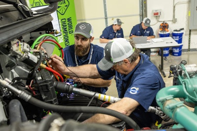 Two men work on a truck at the Volvo VISTA World Championships