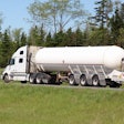 White truck with tanker trailer in country