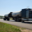 Blurred truck speeding on road