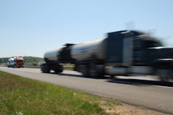 Blurred truck speeding on road