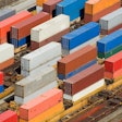 Shipping containers stacked on rail cars