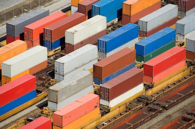Shipping containers stacked on rail cars