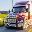 A black grille guard on a red Peterbilt truck.