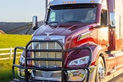 A black grille guard on a red Peterbilt truck.