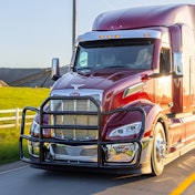 A black grille guard on a red Peterbilt truck.