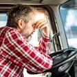 A frustrated driver behind the wheel of a truck