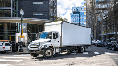 Box truck turning on a city street