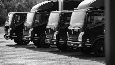 Bollinger Motors trucks parked in a lot