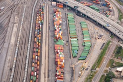 Trains idled in a railyard.