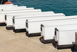 Row of white trailers on pier