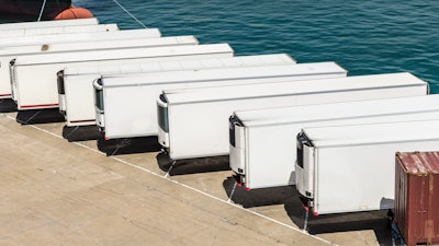 Row of white trailers on pier