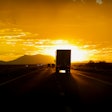 Truck driving into sun