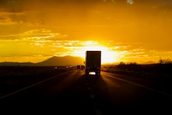 Truck driving into sun