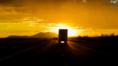 Truck driving into sun