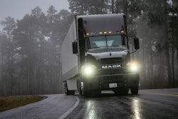 A truck driving in the rain.