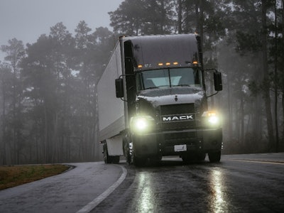 A truck driving in the rain.