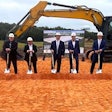 A group of people with shovels at a construction site.