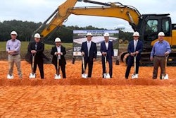 A group of people with shovels at a construction site.
