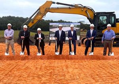 A group of people with shovels at a construction site.