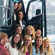 A group of women in a tractor with an open door.