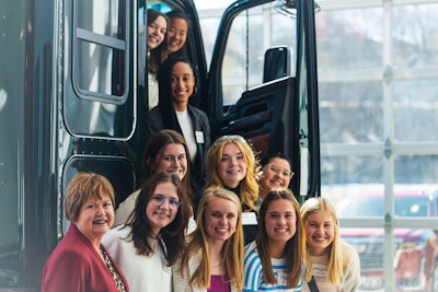 A group of women in a tractor with an open door.