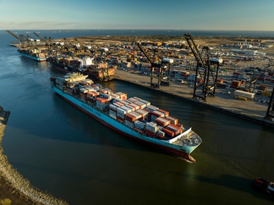 A container ship sails into the port of Houston