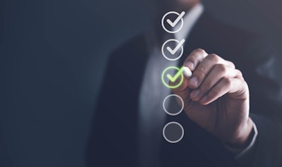 Man checking off list on screen