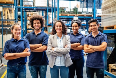 A group of people stand in front of shelves of goods