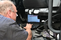 Technician using computer in a shop