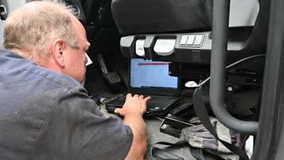 Technician using computer in a shop