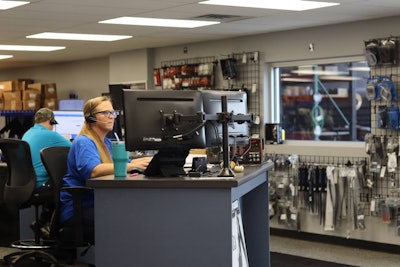 A woman works at a computer at a trucks parts company
