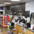 Two men work behind a counter in a parts store