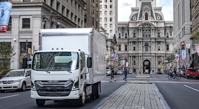 A truck driving down a city street.