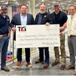 Several men holding a large check from TLG to Samaritan's Purse for $100,000.
