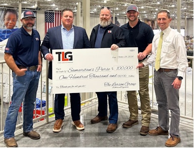 Several men holding a large check from TLG to Samaritan's Purse for $100,000.