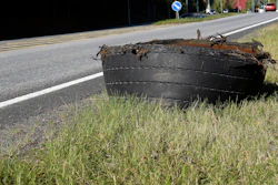 commercial truck tire retread on the side of the road