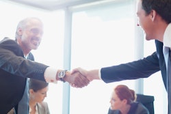 Businessmen shaking hands after a deal