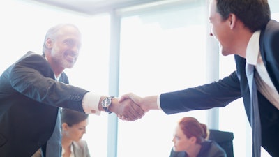 Businessmen shaking hands after a deal