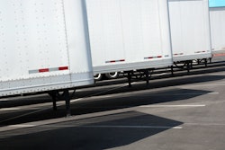 Row of new white trailers in parking lot